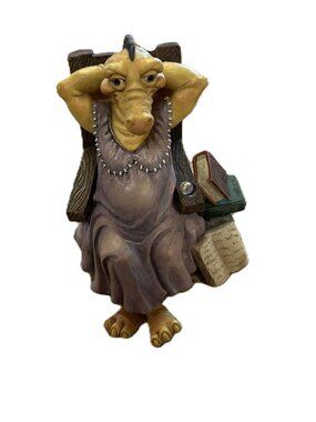 Kystonia - lady dragon sitting in a chair with books